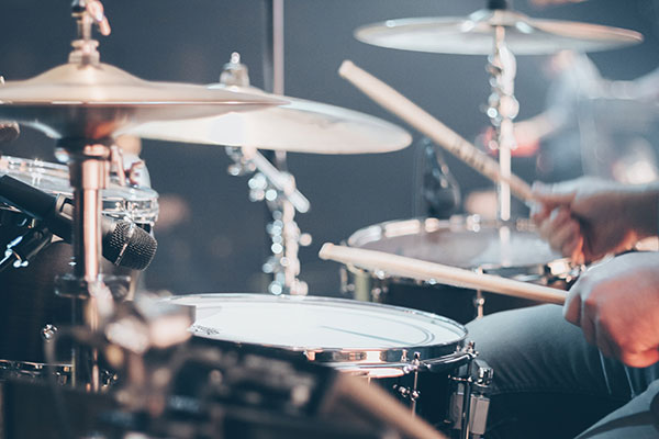 Drummer playing a drum kit with cymbals