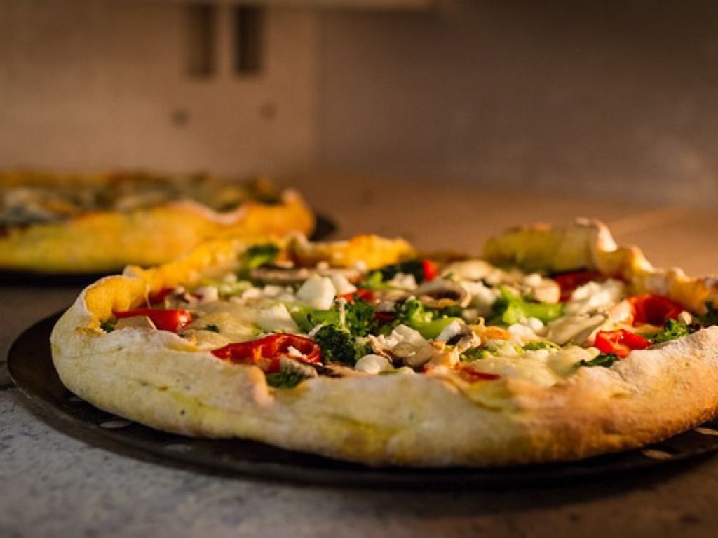 Thick-crust pizza topped with broccoli, mushrooms and peppers.