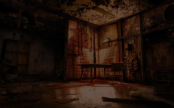 Dark horror-themed room with stained tile walls, hanging chains, a table and a chair.
