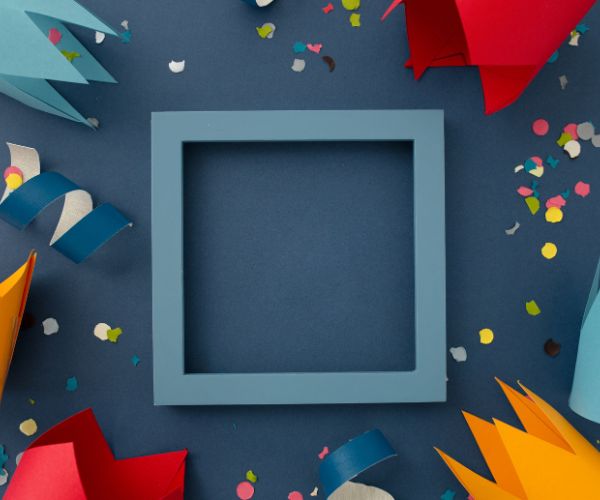 Blank blue square frame surrounded by confetti and curled paper ribbons