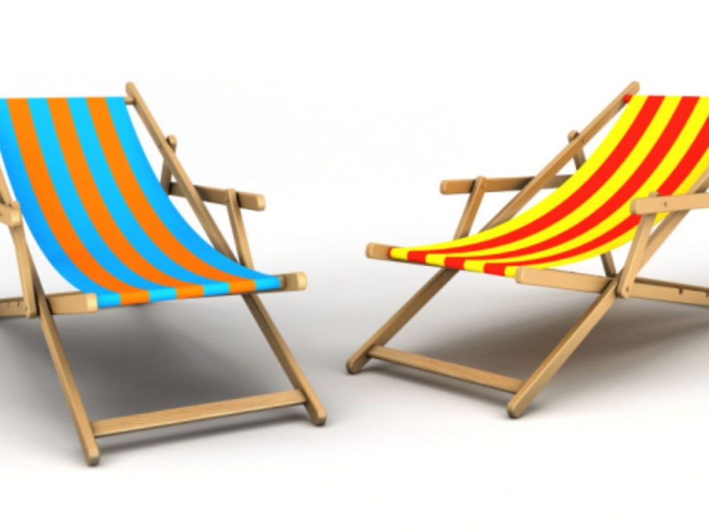 Two wooden deck chairs with blue-and-orange and red-and-yellow striped seats
