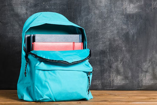 Turquoise backpack holding books