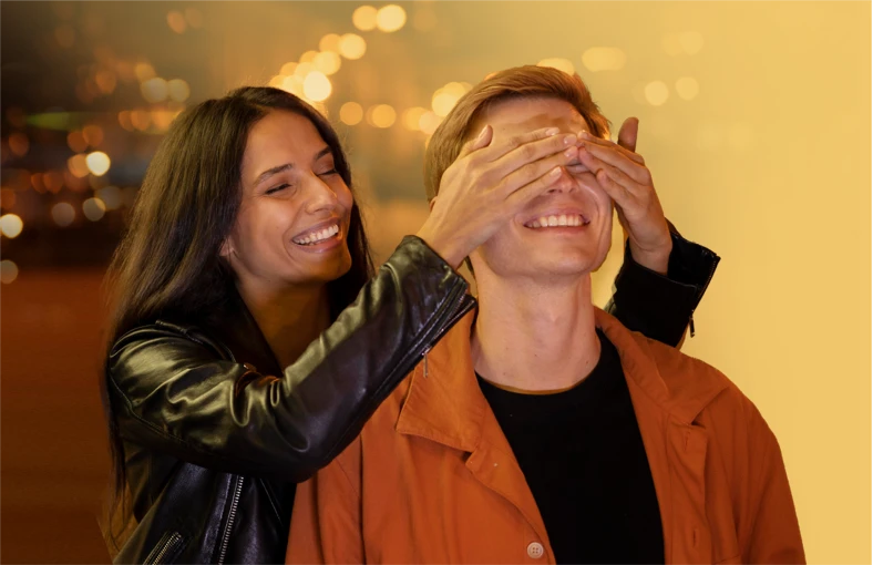 One partner playfully covers the other’s eyes for a surprise.