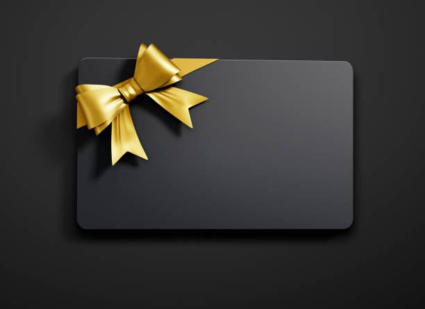 Black gift card with gold ribbon bow on dark background