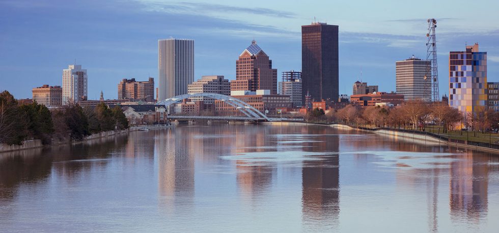 Rochester, NY downtown skyline and bridge reflecting in Genesee River