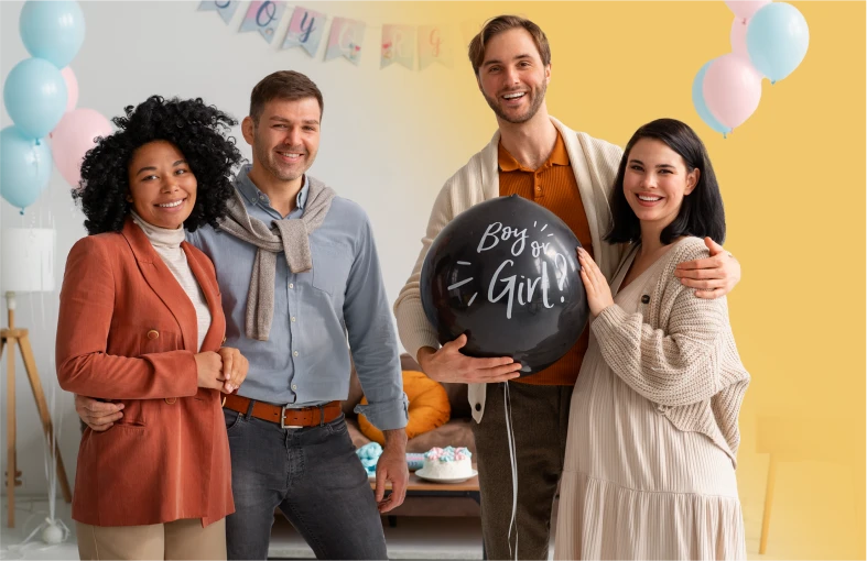 Friends hold a Boy or Girl balloon at a gender-reveal celebration.